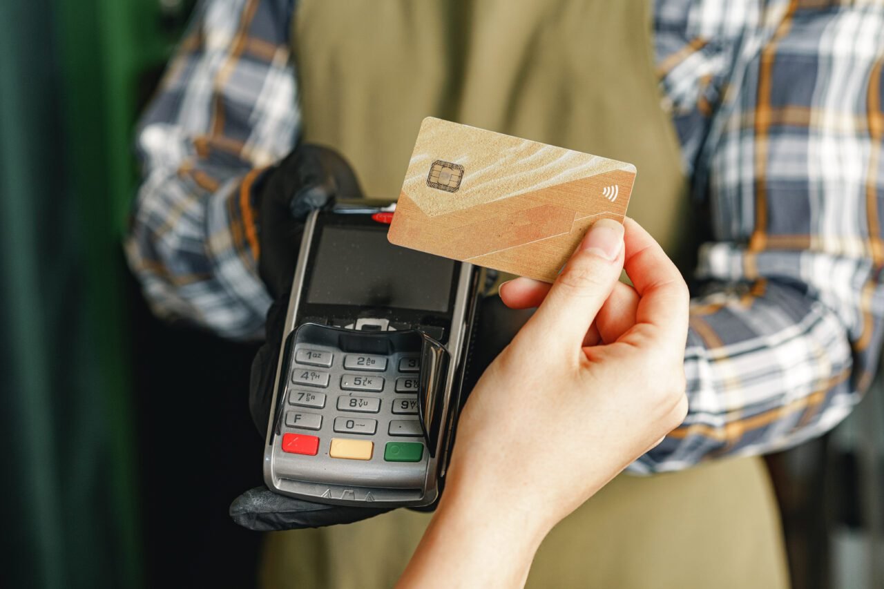 Customer using credit card for payment at cafe or shop by terminal with nfc cashless technology