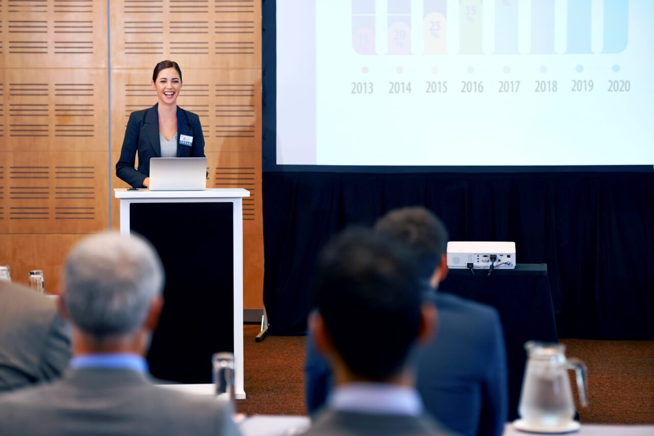 A beautiful young businesswoman giving a presentation at a press conference