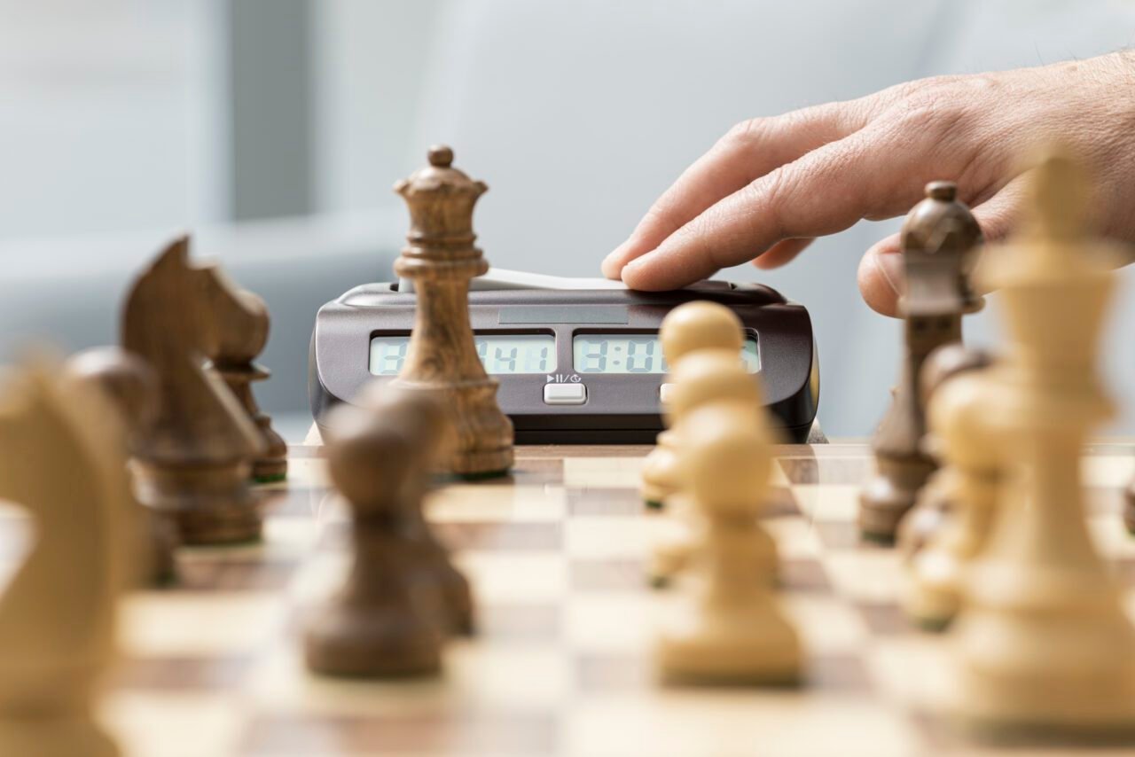 Chess player hitting the chess clock