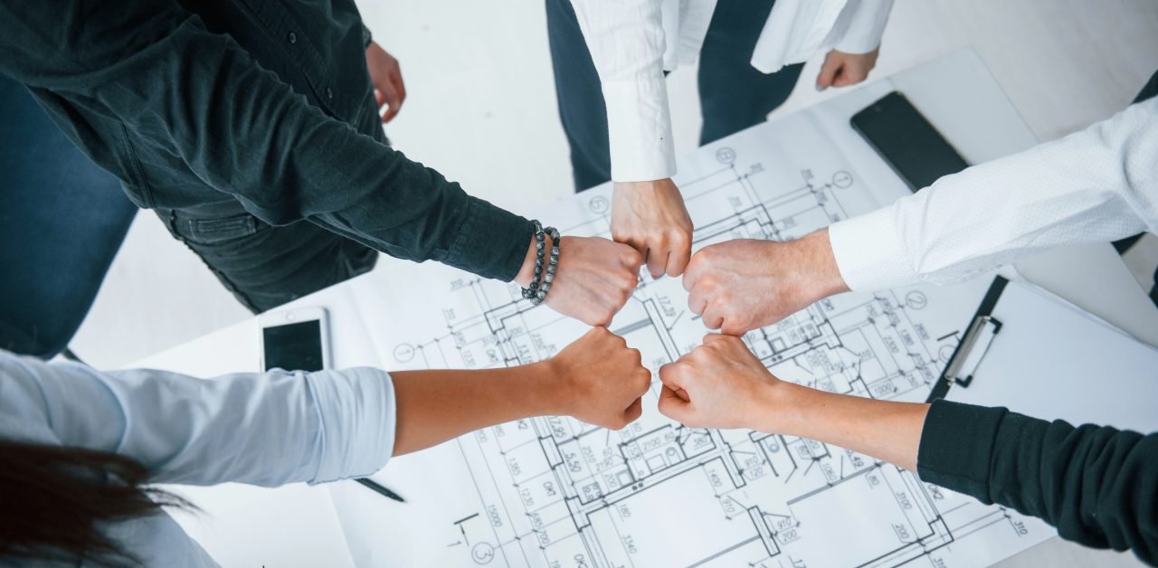 Close up view of hands of business people that celebrating success in the office