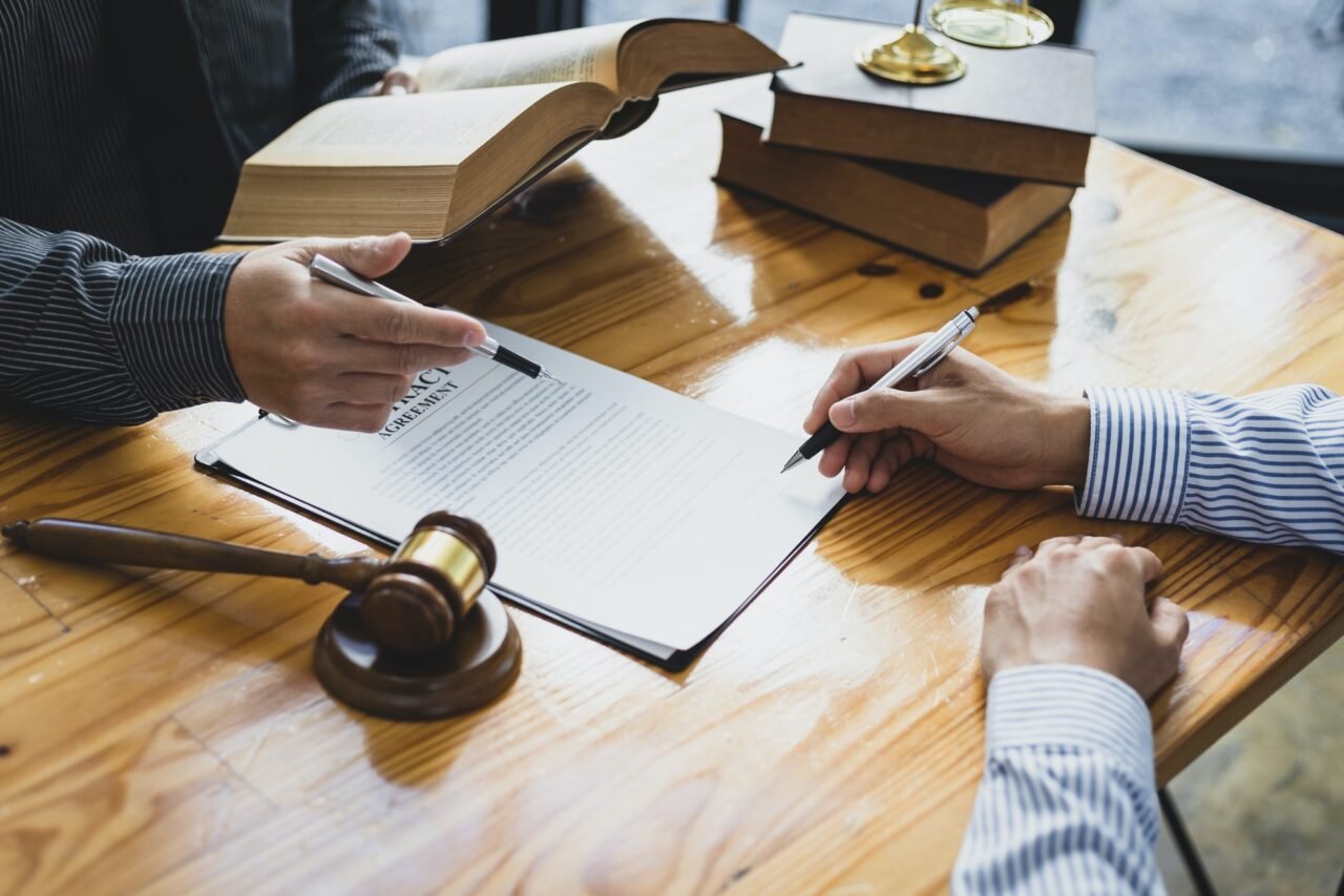 Legal consulting services, legal negotiations, Lawyer are signing legal contract agreement document.