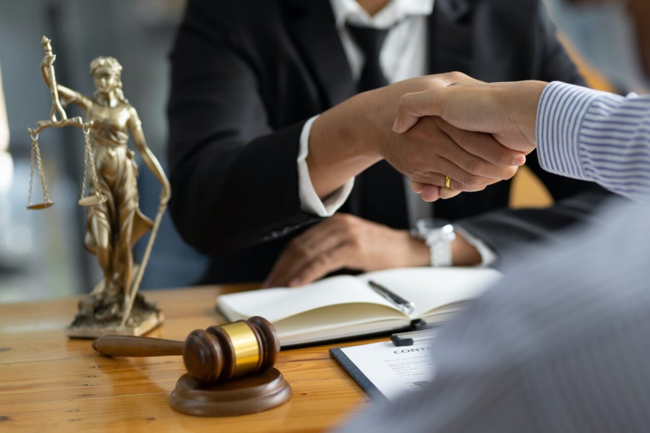 Legal consulting services, legal negotiations, Lawyer are signing legal contract agreement document.