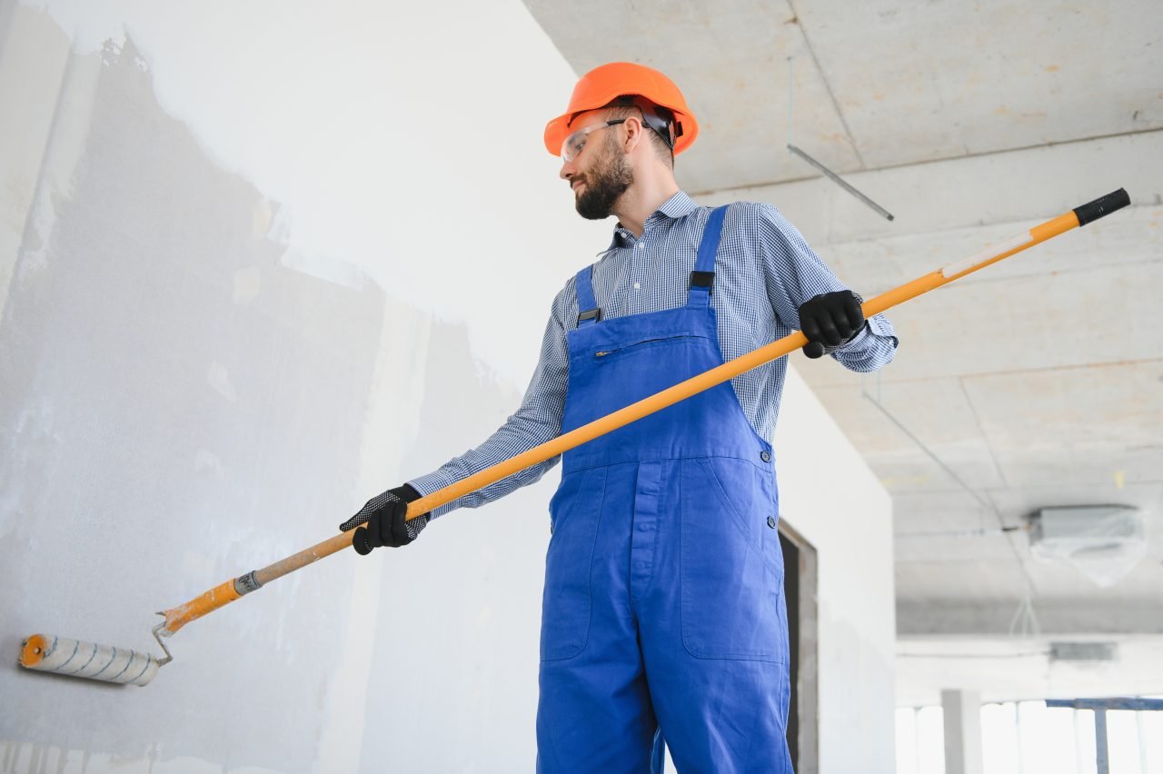 painter man painting the wall, with paint roller