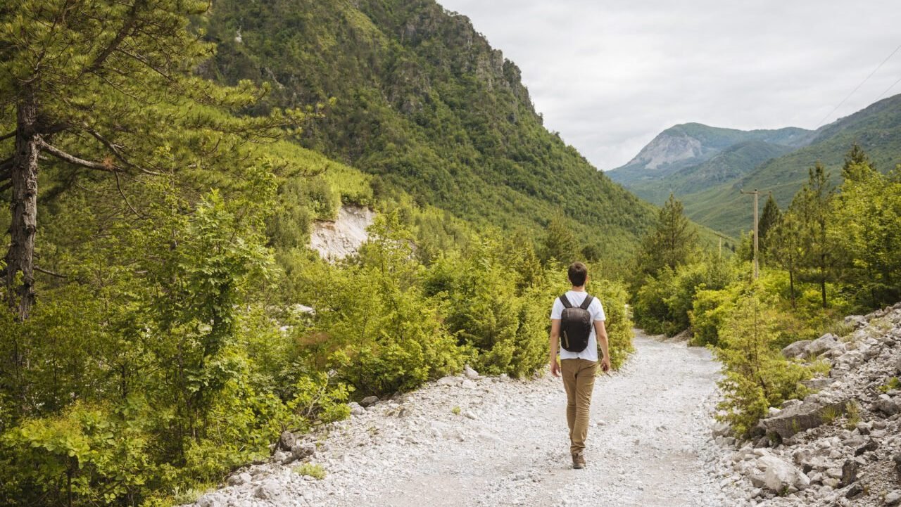 Hiker hiking in Accursed mountains, Theth, Shkoder, Albania, Europe