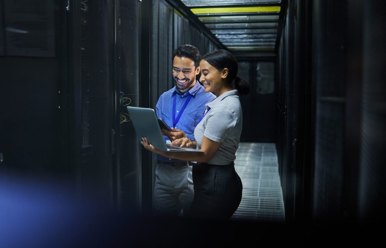 Server room, laptop and technician people for software management, system upgrade or cyber security
