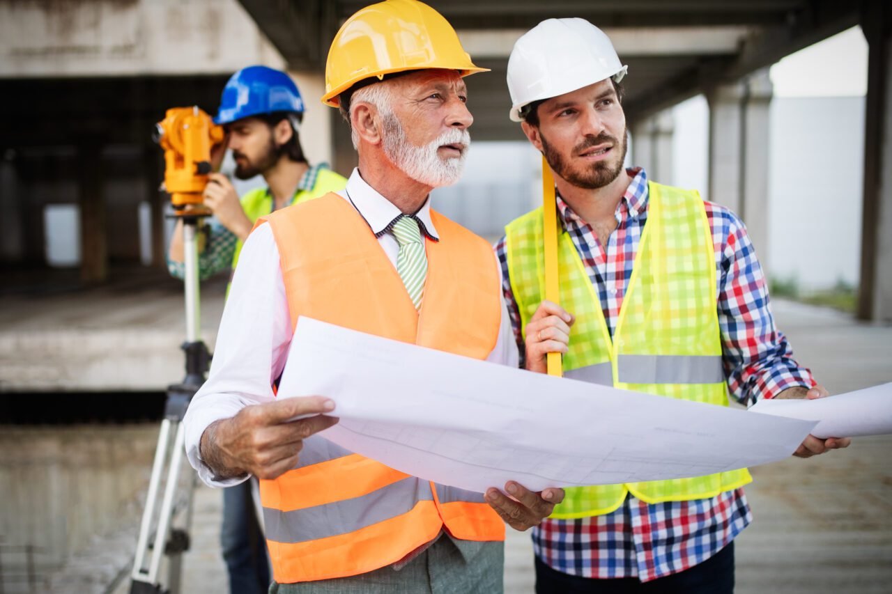 Construction engineers discussion with architects at construction or building site