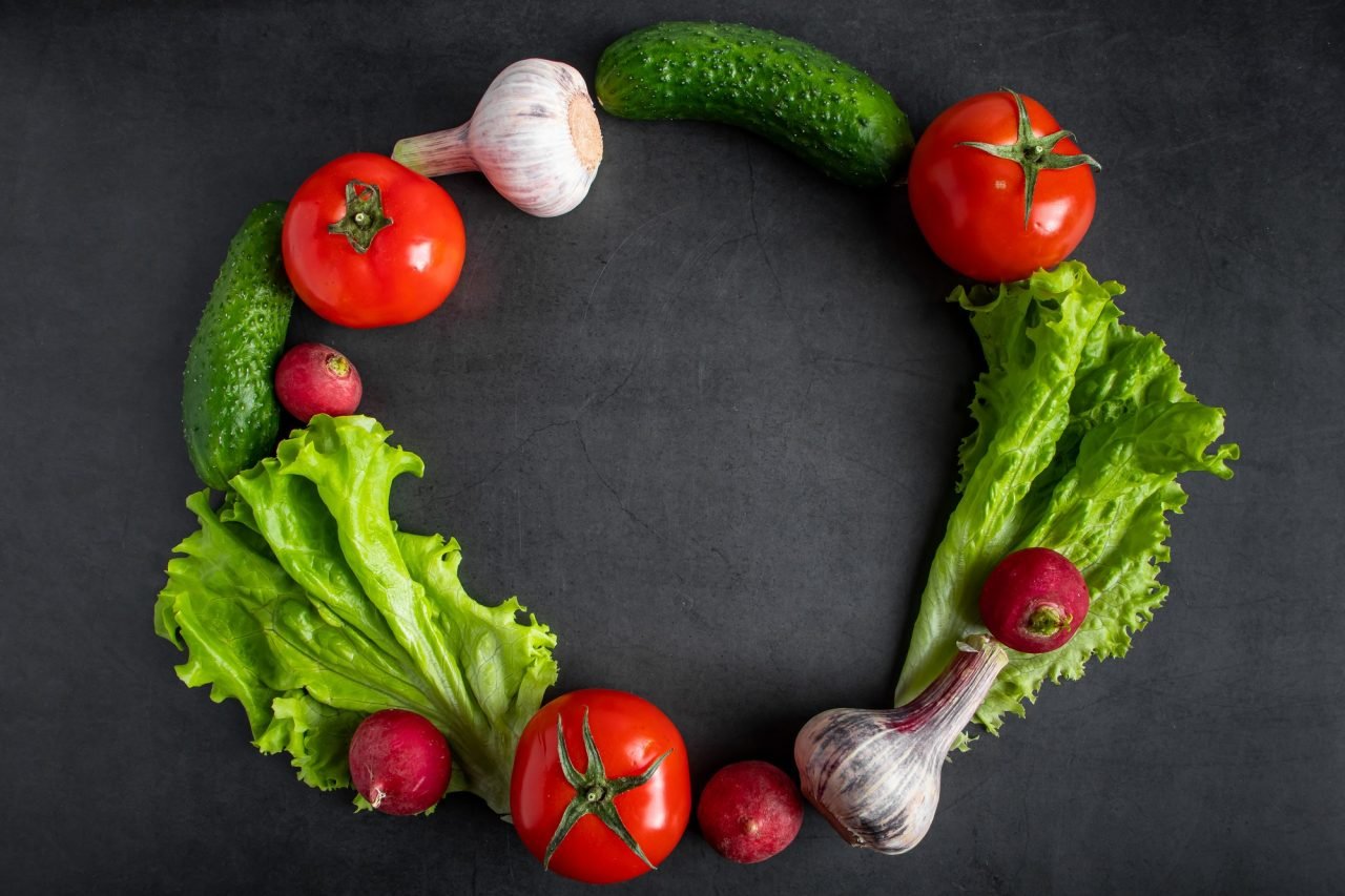 Fresh vegetables on a dark background. The concept of healthy nutrition and diet