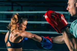 Woman on boxing training with trainer